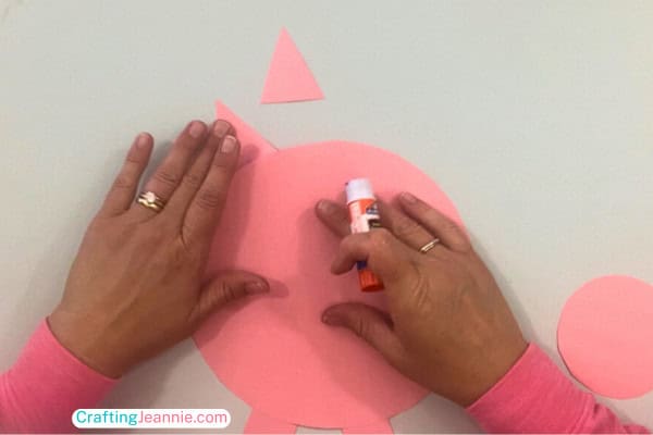 step two of paper pig - glue on ears