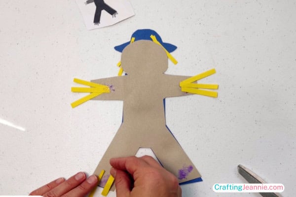 glue the yellow paper hay onto the back of the scarecrow