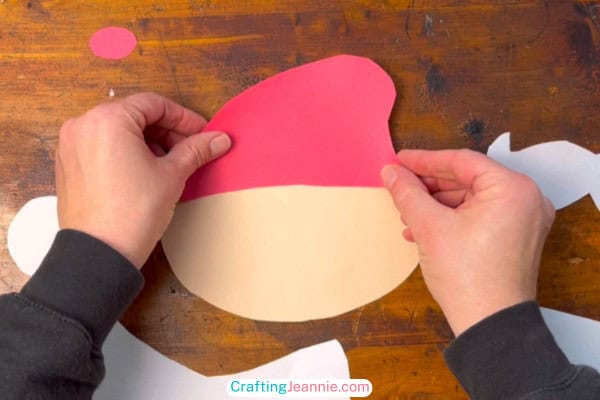 step 1 of santa craft glue on red hat