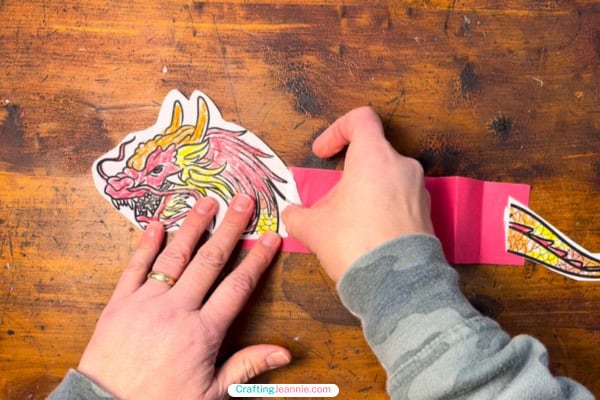 Tape the dragon's head to one side of the paper